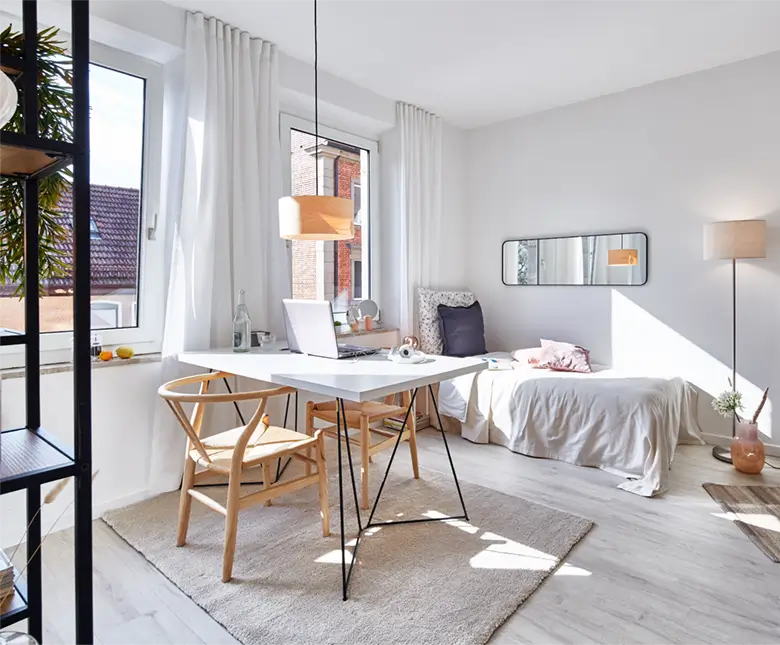 Blick in das Zimmer mit Schreibtisch und Bett